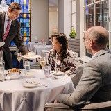 people sitting around a table in a restaurant