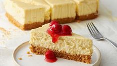 a piece of cheesecake with cherries on top