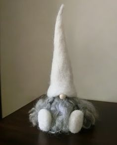 a white gnome hat sitting on top of a wooden table