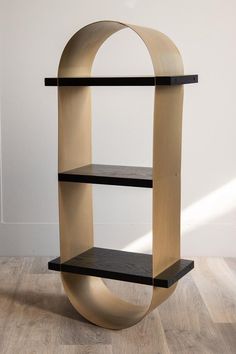 a book shelf with two shelves on each side and an oval design at the top