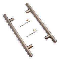 three metal handles and two screws on a white background