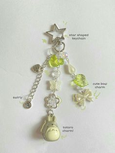 a keychain with charms attached to it's sides and words describing the parts of a key chain