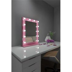 a desk with a mirror and lights on it