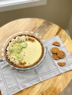 a pie with cucumbers and crackers on a table