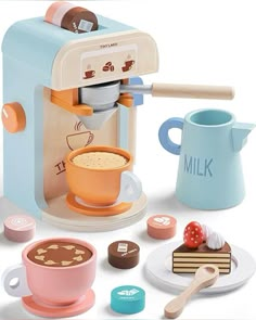 a toy coffee maker with cups and saucers