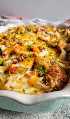 a casserole dish with meat, cheese and vegetables