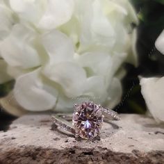 a diamond ring sitting on top of a rock