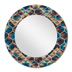 a round mirror with blue, brown and white designs on the front surface is shown