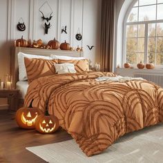 a bed room with a neatly made bed and two pumpkins