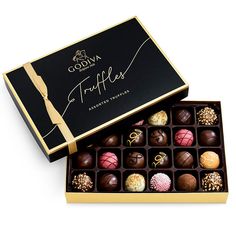 the gourmet truffles box is filled with assorted chocolates,