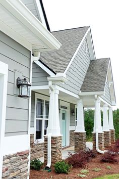 a row of houses with white pillars and windows