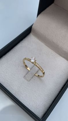 an open box with a ring in it