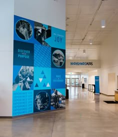 a large blue and white wall with pictures on it's side in an airport