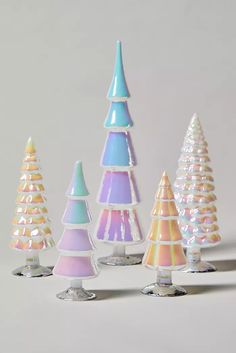 five small plastic trees are lined up in a row