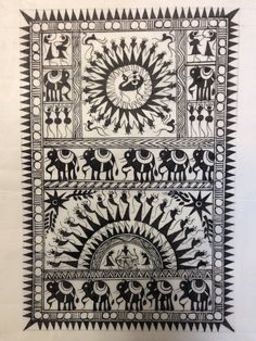 an intricately designed wall hanging with black and white artwork on it's sides