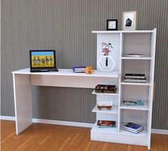 there is a white desk with books and a laptop on the shelf next to it