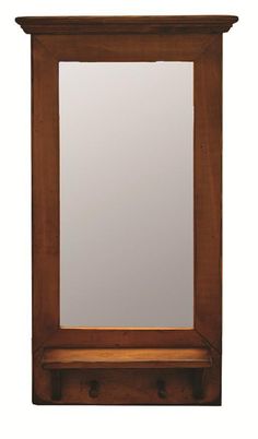 a wooden frame mirror on top of a shelf