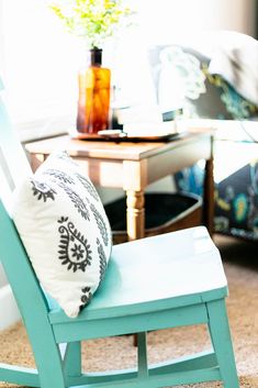 a blue rocking chair with a pillow on it