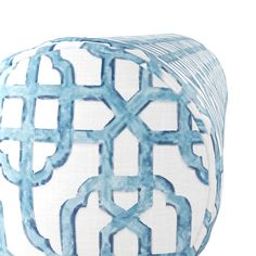 a blue and white pillow with an intricate design on it