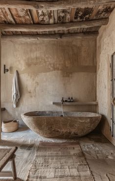 a large stone bath tub in a rustic bathroom