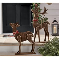 two wooden reindeer statues on the front porch