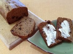 sliced loaf of bread sitting on top of a green plate next to another piece of bread