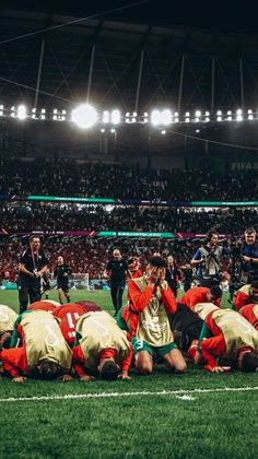 a group of people standing on top of a soccer field