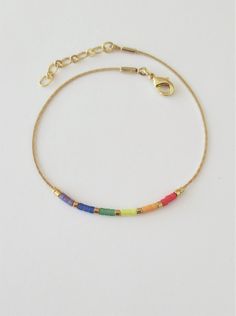 "Thin LGBT flag bracelet. Delicate Rainbow jewelry. This listing for one bracelet. On the 1st image is shown bracelet version #7. All version are available in gold tone or silver tone. DETAILS - Japanese color glass seed beads - Dainty but strong chain - Bracelet Version (Rainbow). Available 7 versions with gold tone chain&spacers and 7 with silver tone chain&spacers. You can also create your own version :) - Bracelet Length. Choose in the drop down menu (1 inch = 2.5 cm) - Two stoppers Pride Flag Bracelet, Gay Pride Bracelet, Lgbt Bracelet, Lgbtq Support, Flag Bracelet, Pride Bracelet, Japanese Colors, Lgbt Flag, Rainbow Jewelry