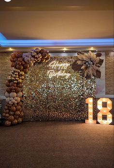 the entrance to an event is decorated with lights and balloons, as well as a large number