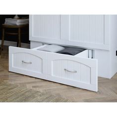 a white cabinet with two drawers underneath it