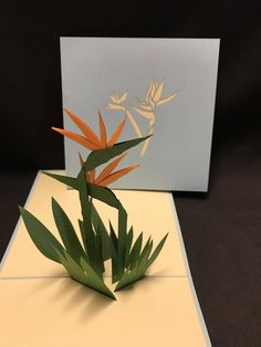 an origami bird of paradise on a card