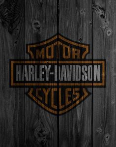 the harley davidson logo on a wooden wall