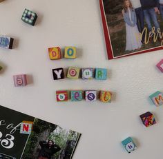 magnets that spell out the word do your best on a refrigerator door next to photos