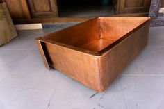 a large metal tub sitting on top of a tiled floor