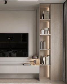 a living room with white furniture and a flat screen tv mounted on the wall above it