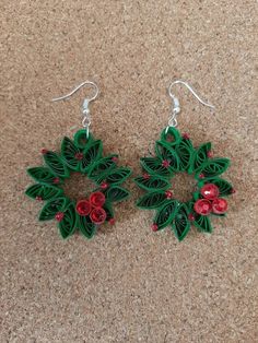 the earrings are made out of green and red paper