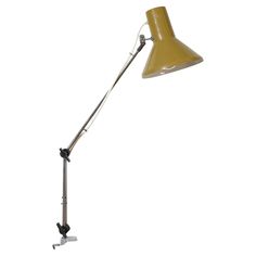 a yellow desk lamp with a metal arm on a white background, the light is turned off