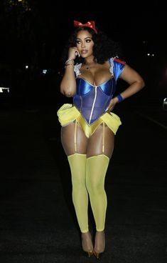 a woman in a blue and yellow corset is talking on her cell phone