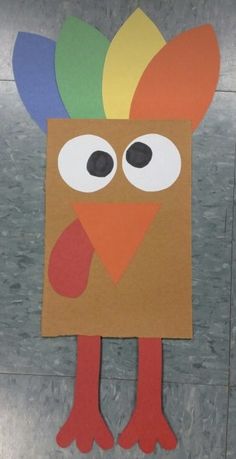 a paper cut out of a turkey with big eyes