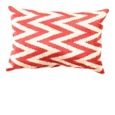 a red and white pillow on a white background