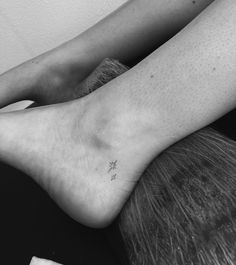 two feet with small tattoos on them