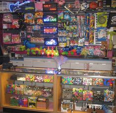 a toy store filled with lots of toys and games on the wall behind the cash register