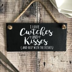 a sign that says i love cuddles and kisses and help with the dishes