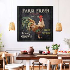 a kitchen table with chairs and a rooster poster on the wall