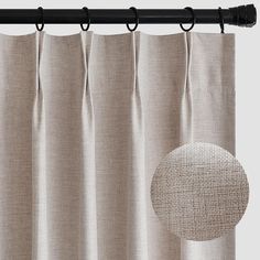 a curtain with a circle on it and a black metal rod hanging from the side