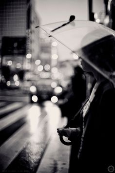 a woman holding an umbrella on a rainy day