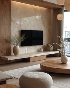 a living room filled with furniture and a flat screen tv on top of a wall