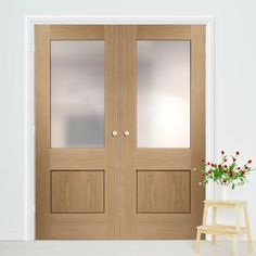 two wooden doors with frosted glass in front of a white wall and small stool