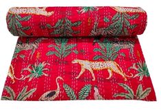 an image of a red and gold fabric with leopards on the side, surrounded by palm trees