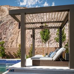 an outdoor lounge area next to a swimming pool